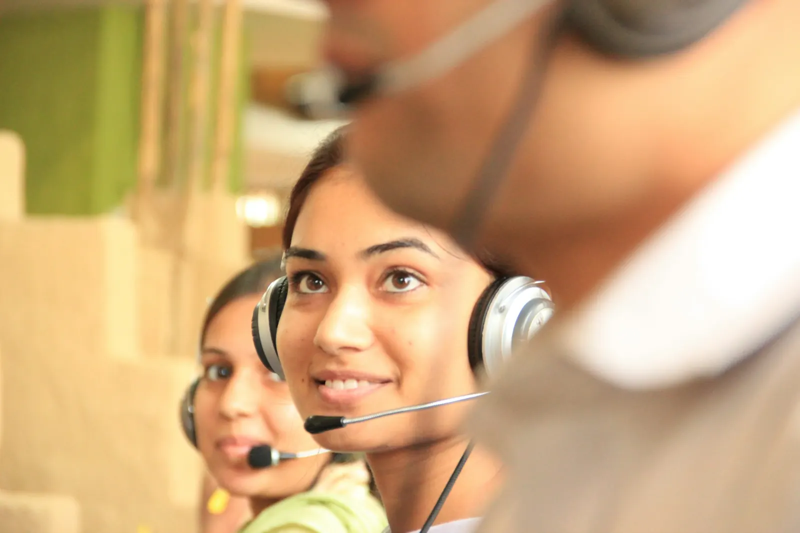 Support agents with headsets helping customers