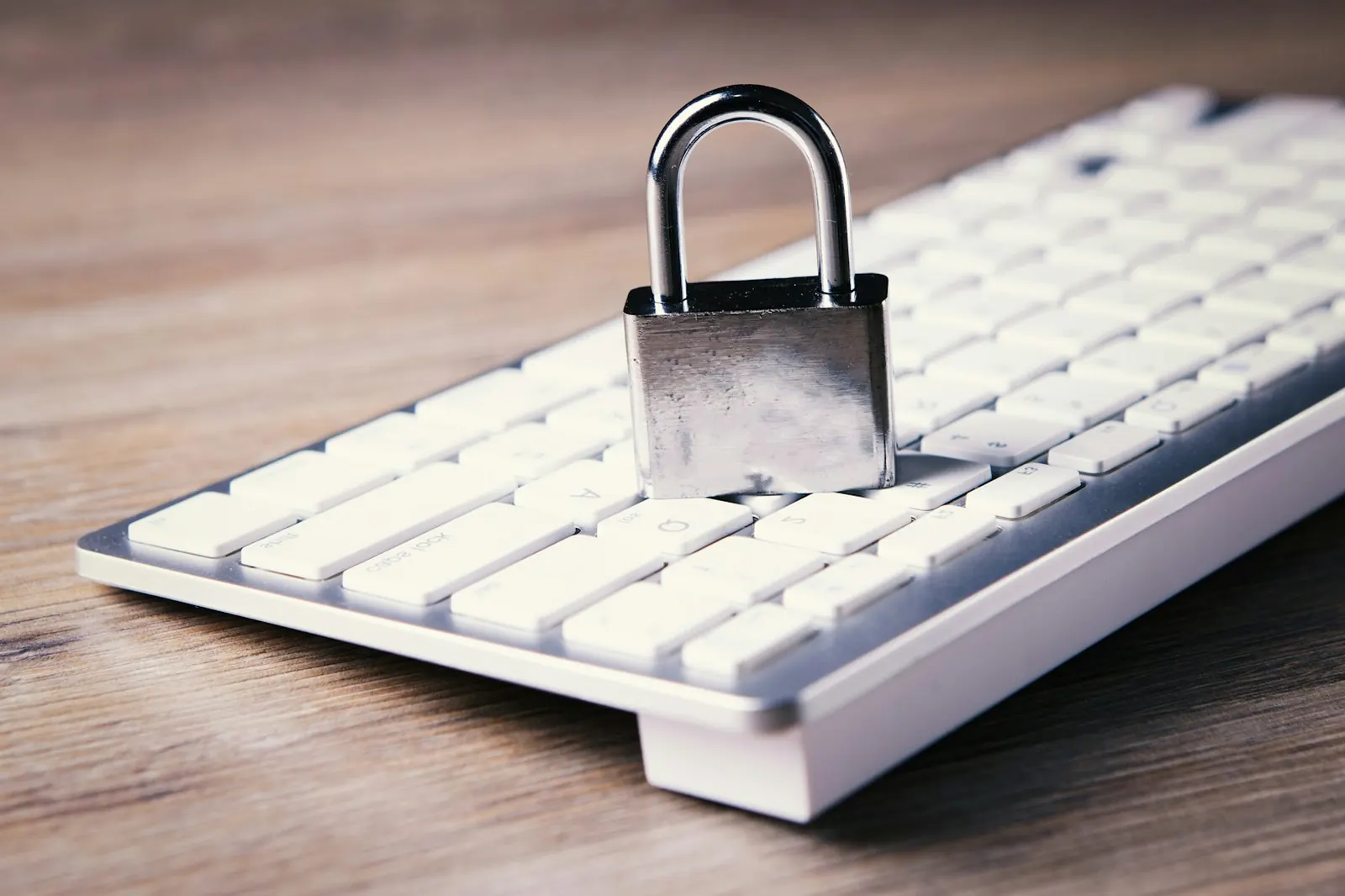 A padlock resting on a computer keyboard